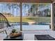 Inviting pool area with stone surround, lush green lawn, and tall trees providing privacy at 462 Barber Loop, Mooresville, NC 28117