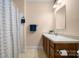 Traditional bathroom features a shower and a single sink vanity with wooden cabinets at 468 White Oak Branch Rd, Statesville, NC 28625