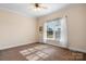 Bedroom featuring neutral carpet, natural light, and a large window with white curtains at 468 White Oak Branch Rd, Statesville, NC 28625