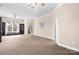 Spacious bedroom featuring neutral carpet, ceiling fan, and sitting area with built-in shelving at 468 White Oak Branch Rd, Statesville, NC 28625