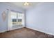 A cozy bedroom with a bright window, plush carpet, and soft blue walls at 468 White Oak Branch Rd, Statesville, NC 28625