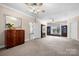 Spacious bedroom featuring neutral carpet, ceiling fan, and sitting area with built-in shelving at 468 White Oak Branch Rd, Statesville, NC 28625