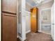 Walk-in closet with built-in wooden shelving, leading to a bathroom with a soaking tub at 468 White Oak Branch Rd, Statesville, NC 28625