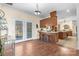 Dining area with hardwood floors, patio access, and bar seating, creating a versatile space for meals and entertaining at 468 White Oak Branch Rd, Statesville, NC 28625