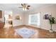 Open-concept living room featuring wood floors, large window, and a view into the kitchen at 468 White Oak Branch Rd, Statesville, NC 28625