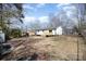 Expansive backyard featuring a wooden deck and a mature tree line, offering a private outdoor space at 523 Hickory Nut Ln, China Grove, NC 28023