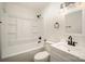 The bathroom boasts a shower-tub combo, white vanity, updated mirror and lighting, creating a spa-like ambiance at 523 Hickory Nut Ln, China Grove, NC 28023