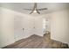 This bedroom boasts wood floors, a ceiling fan, and access to a private bathroom, offering comfort and privacy at 523 Hickory Nut Ln, China Grove, NC 28023