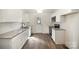 Bright kitchen featuring granite countertops, white cabinets, stainless steel appliances, and wood flooring at 523 Hickory Nut Ln, China Grove, NC 28023