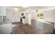 Bright, airy kitchen featuring stainless steel appliances, granite countertops, and new wood flooring at 523 Hickory Nut Ln, China Grove, NC 28023