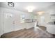 Bright, airy kitchen featuring white cabinets, granite countertops, and new wood flooring at 523 Hickory Nut Ln, China Grove, NC 28023