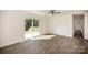 Bright living room featuring neutral paint, sliding glass doors to the deck, and new wood flooring at 523 Hickory Nut Ln, China Grove, NC 28023