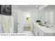 Bathroom features double vanity, white countertops and cabinets, with view to carpeted bedroom and outside view at 544 Zermatt Ct, Monroe, NC 28112