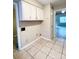 Tiled floor and white cabinetry in kitchen laundry space at 5810 Hunting Ridge Ln # C, Charlotte, NC 28212