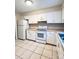 Bright kitchen with white cabinets, appliances and tile flooring at 5810 Hunting Ridge Ln # C, Charlotte, NC 28212