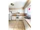 Bright kitchen with white cabinets, appliances and tile flooring at 5810 Hunting Ridge Ln # C, Charlotte, NC 28212