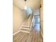 Well-lit staircase featuring modern flooring and white handrails at 5810 Hunting Ridge Ln # C, Charlotte, NC 28212