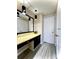 Comfortable vanity with decorative lighting and updated hard surface flooring at 5810 Hunting Ridge Ln # C, Charlotte, NC 28212