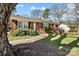 Landscaped front yard with a brick facade and inviting front entrance at 5908 Brookhaven Rd, Charlotte, NC 28210