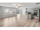 Open floor plan with light hardwood floors connecting the living room and kitchen at 6623 Latherton Ln, Charlotte, NC 28278