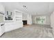 Spacious living room featuring built-in bookshelves and a fireplace, with sliding doors to the backyard at 7141 Lancer Dr, Charlotte, NC 28226