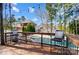 View from a wood deck with seating overlooking the pool at 815 Stratford Run Dr, Fort Mill, SC 29708