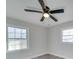 A bright bedroom featuring vinyl floors, neutral paint, a ceiling fan, and plenty of natural light at 8208 Doverdale Ln, Charlotte, NC 28217