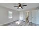 Bedroom with a ceiling fan, hardwood floors, neutral paint, natural light, a closet and ensuite bath at 8208 Doverdale Ln, Charlotte, NC 28217