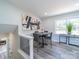 Bright dining area featuring hardwood floors, neutral paint, modern art, and plenty of natural light at 8208 Doverdale Ln, Charlotte, NC 28217