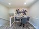 Bright dining area featuring hardwood floors, neutral paint, modern art, and plenty of natural light at 8208 Doverdale Ln, Charlotte, NC 28217