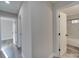 Hallway view showing access to a bathroom and other rooms in the home at 8208 Doverdale Ln, Charlotte, NC 28217