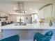 Open-concept kitchen features a spacious island with quartz countertops, stainless steel appliances and modern fixtures at 8208 Doverdale Ln, Charlotte, NC 28217