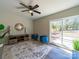 Open-plan living room with sliding doors, stylish furniture, a ceiling fan, and wood-look flooring at 8208 Doverdale Ln, Charlotte, NC 28217
