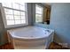 Bathroom with a corner tub offers a relaxing and private space at 828 Carver St, Shelby, NC 28152