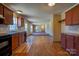 Open-concept kitchen flowing into the dining area, featuring modern appliances and wood flooring at 828 Carver St, Shelby, NC 28152