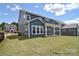 Expansive backyard with a covered patio, lush lawn, and well-manicured landscaping at 000 Millstream Rd # 149, Denver, NC 28037