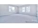 Large bedroom with multiple windows offering lots of natural light and neutral carpet at 000 Millstream Rd # 149, Denver, NC 28037