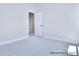 Neutral bedroom with carpet and white trim featuring an open closet door at 000 Millstream Rd # 149, Denver, NC 28037