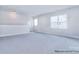 Spacious bonus room featuring neutral carpet and multiple windows with natural light at 000 Millstream Rd # 149, Denver, NC 28037