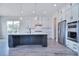 Bright kitchen features a spacious island, stainless steel appliances, and stylish pendant lighting at 000 Millstream Rd # 149, Denver, NC 28037