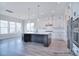 Large kitchen island is featured in this open concept kitchen with modern appliances at 000 Millstream Rd # 149, Denver, NC 28037