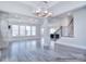 Spacious living room with coffered ceilings, large windows, and hardwood floors at 000 Millstream Rd # 149, Denver, NC 28037