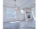 Bright, airy living room with a stone fireplace and large windows with views at 000 Millstream Rd # 149, Denver, NC 28037