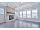 The living room is bright and airy with a cozy fireplace and a wall of windows that let in ample light at 000 Millstream Rd # 149, Denver, NC 28037
