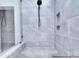 Large, walk-in shower featuring gray tile, a built-in seat, and shower niche at 000 Millstream Rd # 149, Denver, NC 28037