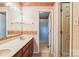 Traditional bathroom with single sinks, vanity, floral wallpaper, and large mirror at 1007 Wentworth Dr, Kannapolis, NC 28081