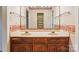 Traditional bathroom with double sinks, vanity, floral wallpaper, and large mirror at 1007 Wentworth Dr, Kannapolis, NC 28081