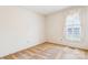 Bright bedroom offers neutral carpet and a sun-filled window with shutters at 1007 Wentworth Dr, Kannapolis, NC 28081