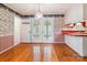Charming dining area featuring hardwood floors, classic wallpaper, and access to a sunroom at 1007 Wentworth Dr, Kannapolis, NC 28081