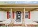 Inviting home entrance with covered porch, decorative door, and charming red shutters at 1007 Wentworth Dr, Kannapolis, NC 28081